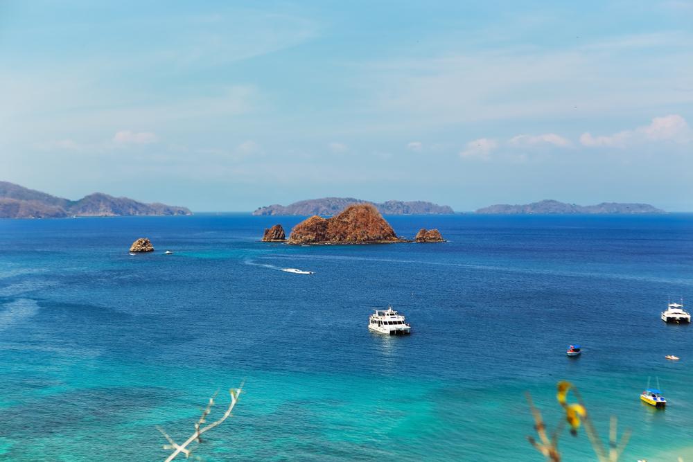 A view of the Nicoya bay with various tourist boats heading towards the shores of Tortuga island in Costa Rica